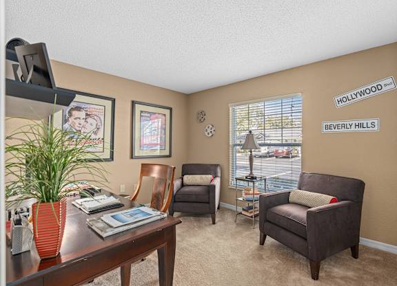 a living room with a desk and chairs and a window at Oak Reserve at Winter Park, Winter Park
