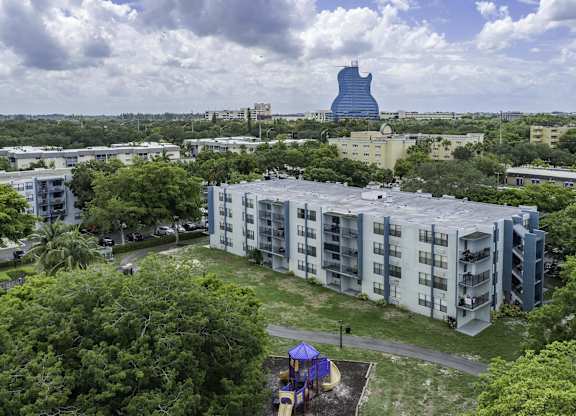 an aerial view of a building with a large blue object in the background  at Club at Emerald Waters, Hollywood, FL