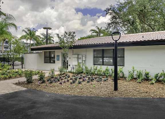a white house with a garden in front of it  at Club at Emerald Waters, Florida