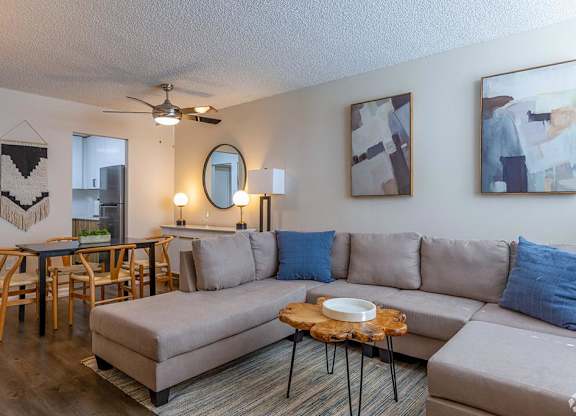 a living room with a couch and a table with chairs  at Club at Emerald Waters, Hollywood, Florida