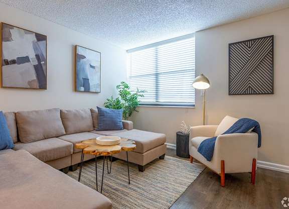a living room with a couch chair and coffee table  at Club at Emerald Waters, Hollywood, 33021