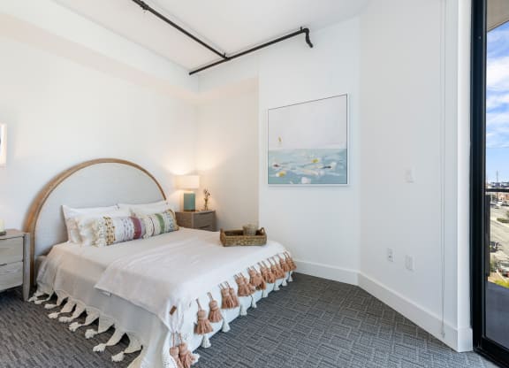 Bedroom with low platform bed and boho decor.