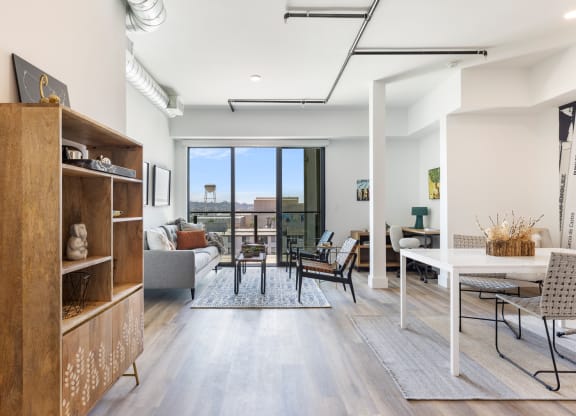 Large kitchen facing a balcony with a lot of natural lighting. The room is decorated with mid century furniture.