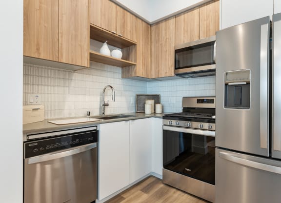 Kitchen area with sink, wooden cabinetry and stainless steel appliances