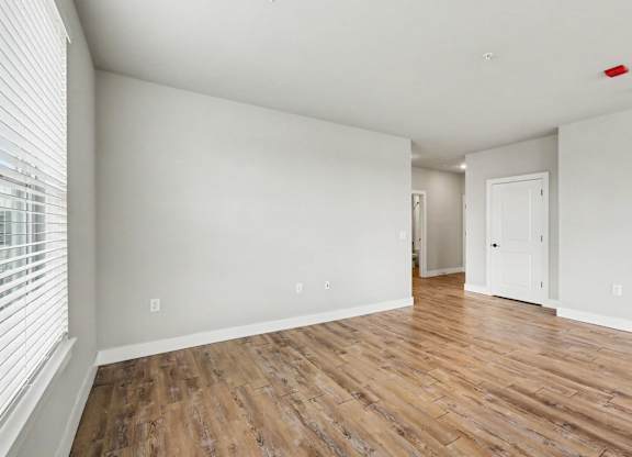 A room with wooden floors and white walls.