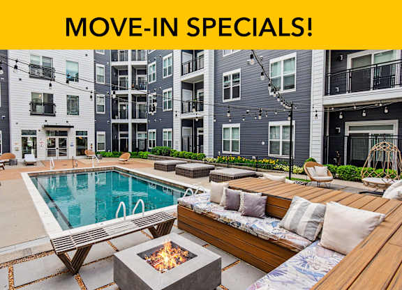 A poolside area with a fire pit and seating area.