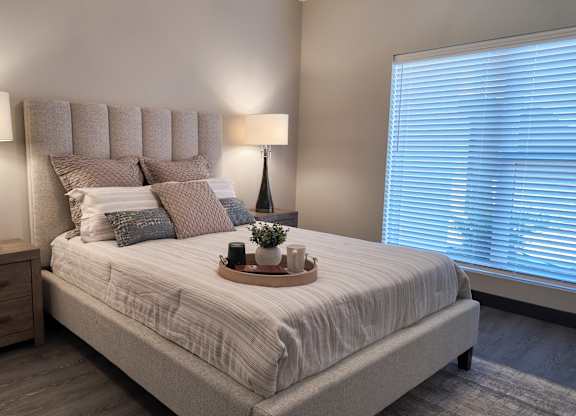 Bedroom with nightstand and lamp at Artisan, O’Fallon