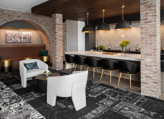 Modern resident lounge with clubroom kitchen and conversational seating  at Chapter at the Streets of St Charles, Missouri, 63303