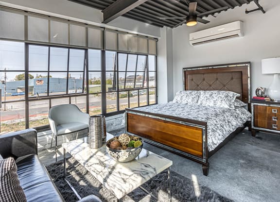 Steelcote Crossing bedroom area with concrete flooring and oversized windows at Steelcote Square, St. Louis, Missouri