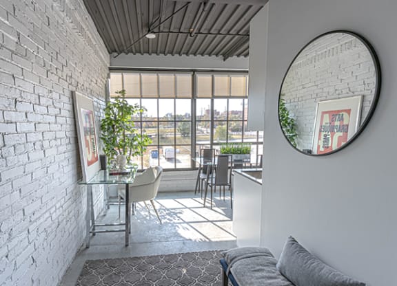 Steelcote Crossing entry way with exposed white brick wall, oversized windows and concrete flooring at Steelcote Square, Missouri, 63103