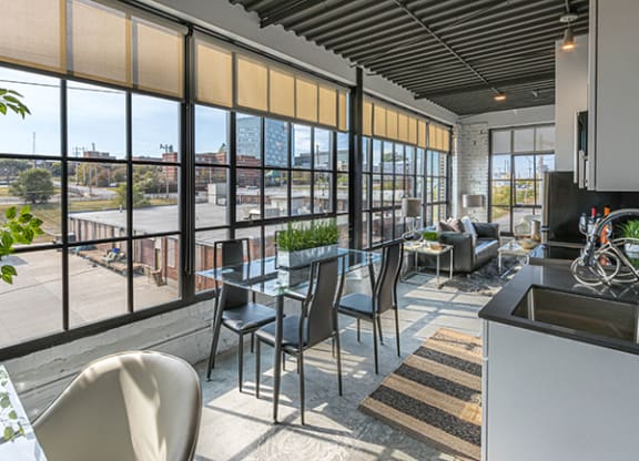 Steelcote Crossing living area with dinning room table and oversized windows at Steelcote Square, St. Louis