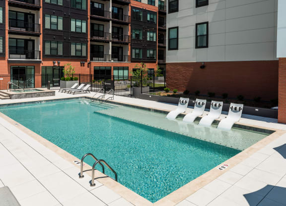 Sparkling pool with sun tanning ledge and hot tub  at Chapter at the Streets of St Charles, Saint Charles, MO
