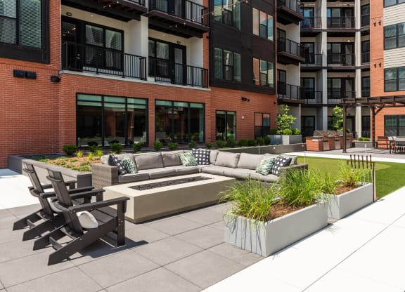 Resident courtyard with fire pit and conversational seating  at Chapter at the Streets of St Charles, Saint Charles, Missouri