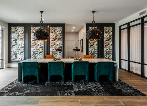 Modern resident lounge with designer lighting and large conference table  at Chapter at the Streets of St Charles, Saint Charles, 63303