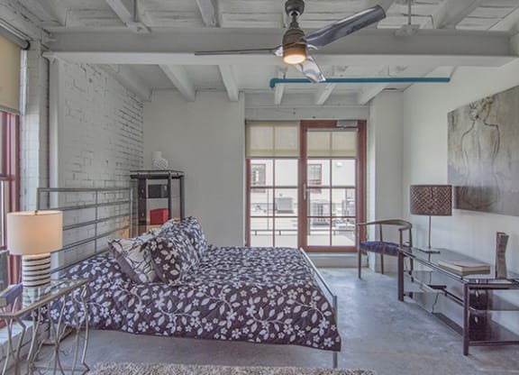Steelcote Lofts bedroom with polished concrete floors, high ceilings and ceiling fan at Steelcote Square, St. Louis