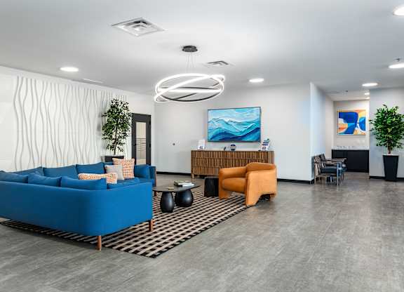 A modern living room with a blue sofa and a wooden table.
