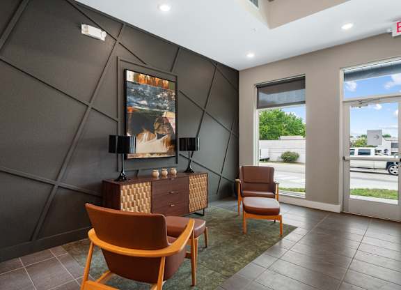 A room with a brown chair and a painting on the wall at The Oliver Apartments, Olivette, Missouri