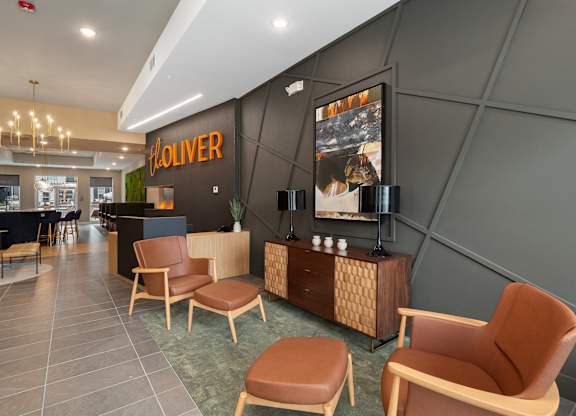 A room with chairs and a sign at The Oliver Apartments, Olivette, MO, 63132