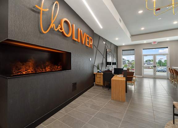 A modern lobby with a fireplace at The Oliver Apartments, Missouri