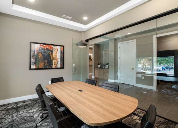 A conference room with a large table and chairs at The Oliver Apartments, Olivette