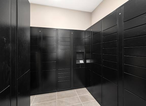 A row of black lockers in a room at The Oliver Apartments, Olivette, 63132