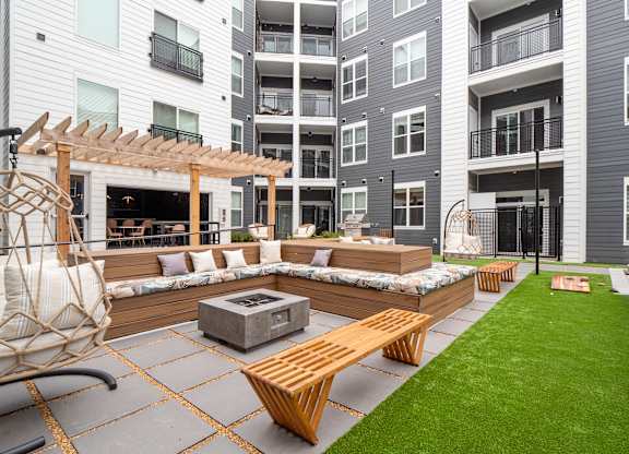 A patio with a fire pit and seating area at The Oliver Apartments, Olivette, MO, 63132