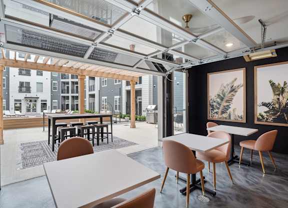 A modern dining area with a glass ceiling and a view of the outside at The Oliver Apartments, Olivette, 63132