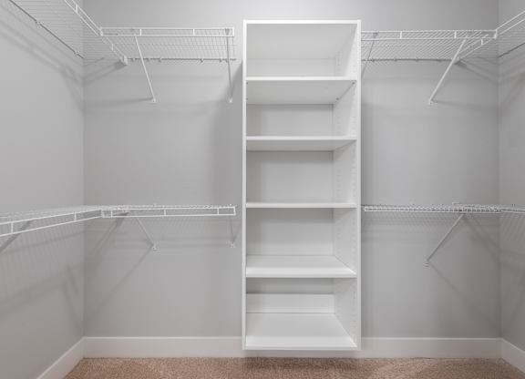 Empty white shelves in a room.