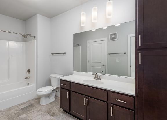A bathroom with a white toilet, a white sink, and a white bathtub.