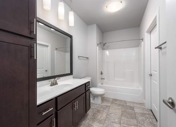 A bathroom with a white tub and a white toilet.