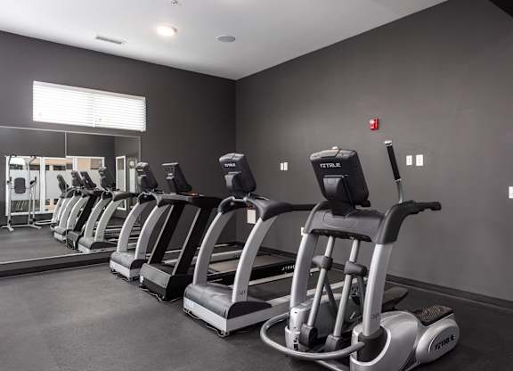 A gym with treadmills lined up.