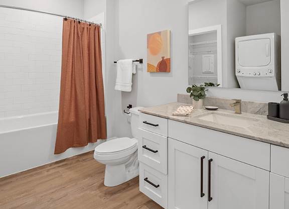 A bathroom with a toilet, sink, and shower at The Oliver Apartments, Missouri