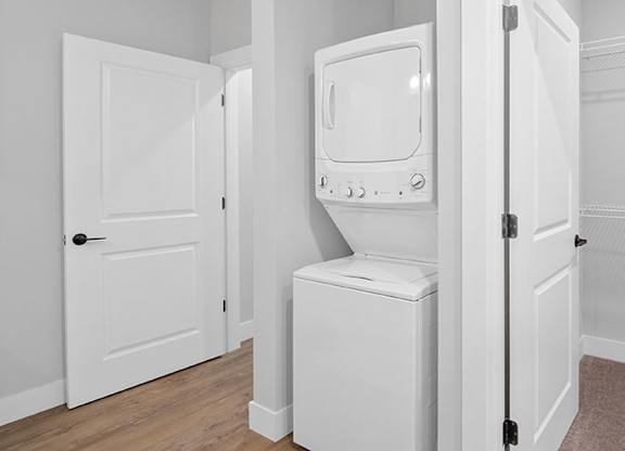 A white fridge and toilet in a small room at The Oliver Apartments, Missouri, 63132