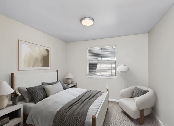 Model Bedroom with Carpet and Window View at Hidden Creek Apartments in Lewisville, TX.