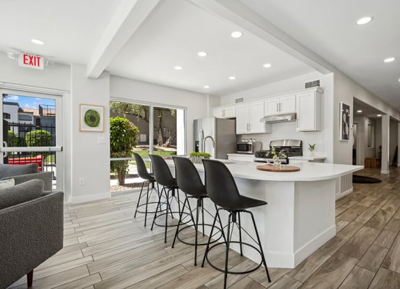Community Clubhouse with Lounge Furniture and Kitchenette Area at Country Club Verandas Apartments located in Mesa, AZ.