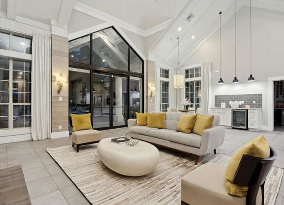Community Clubhouse with Lounge Furniture and Kitchenette Area at Caribbean Breeze Apartments in Tampa, FL.