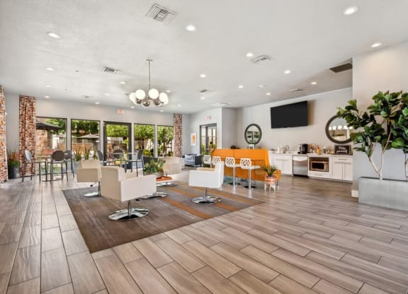 Community Clubhouse with Lounge Furniture and TV at Harmony at Surprise Apartments in Surprise, AZ.