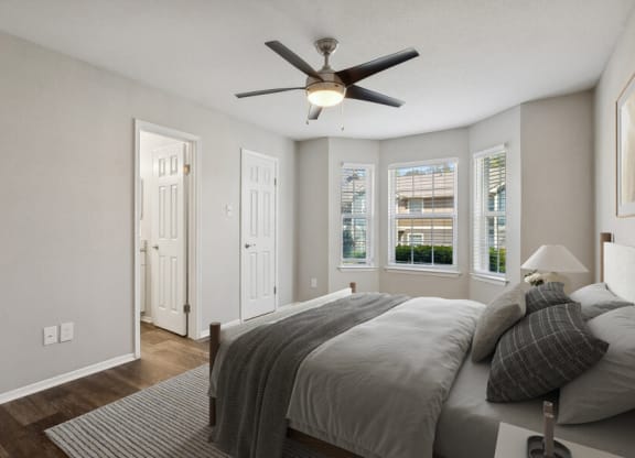 a bedroom with a bed and a ceiling fan