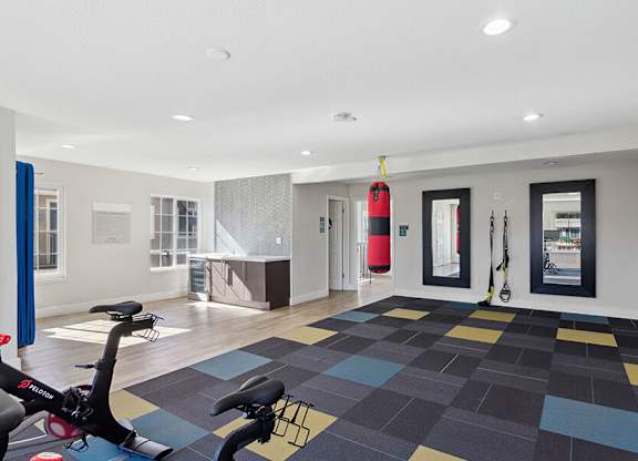 Community Fitness Center with Equipment at Los Gatos Landing Apartments located in San Jose, CA.