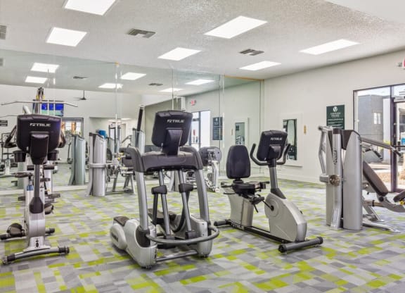 a room filled with lots of different types of exercise equipment