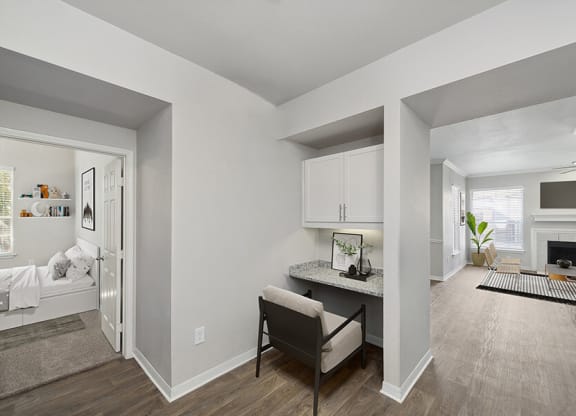 Model Office Area with Wood-Style Flooring and Built in Desk at Chapel Hill Apartments in Lewisville, TX.
