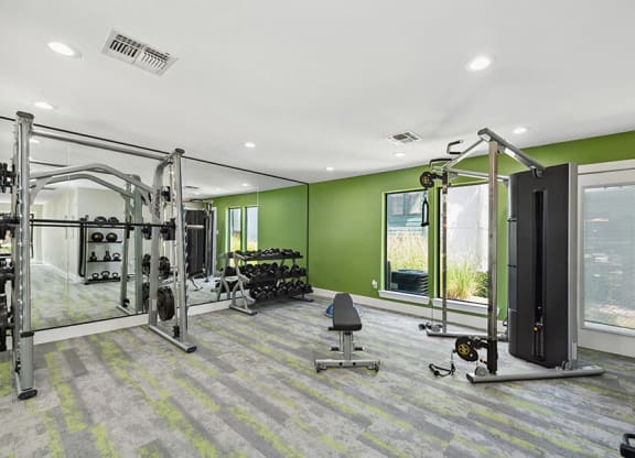 Community Fitness Center with Equipment at Bridges at Deer Run Apartments in Dallas, TX.