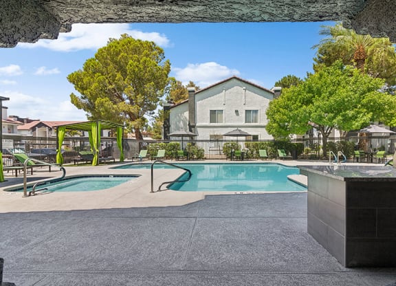 Community Swimming Pool with Pool Furniture at Meadow Ridge Apartments located in Las Vegas, NV.