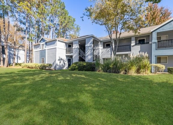 Apartment exterior showcasing landscaping and patios