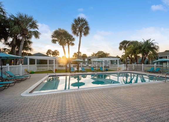 Community Swimming Pool with Pool Furniture at Park at 7200 Apartments in Jacksonville, FL.