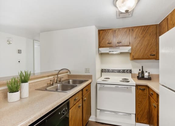 Model kitchen with dishwasher, range, and refrigerator
