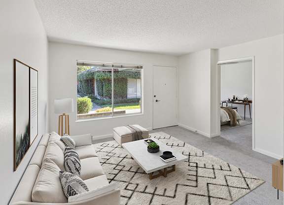 Model Living Room with Carpet and Window View at Walnut Creek Apartments located in Walnut Creek, CA.
