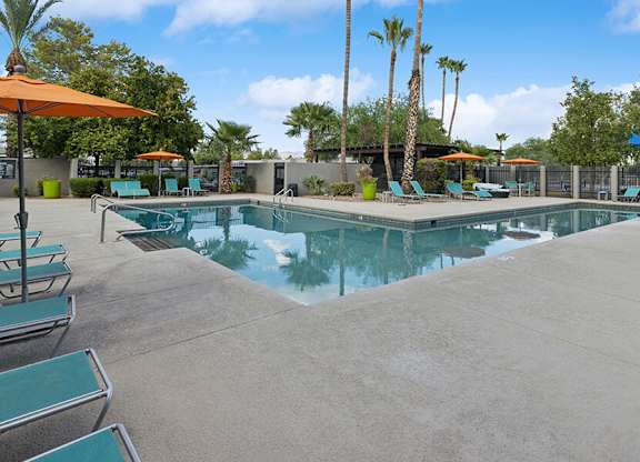 Community Swimming Pool with Pool Furniture at Lakeside Casitas Apartments located in Tucson, AZ.