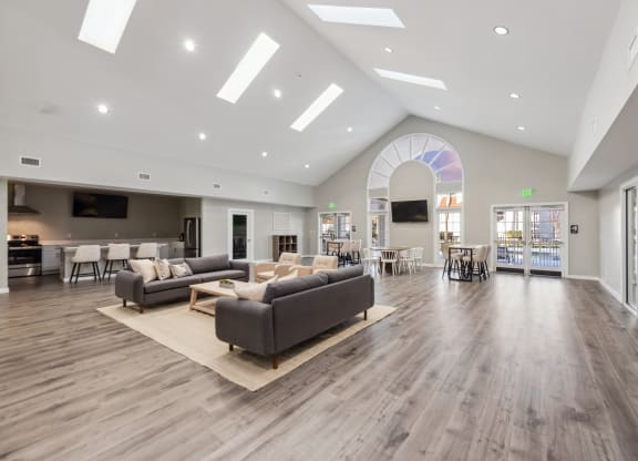a large living room with couches and chairs and a large glass door