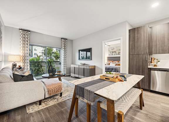 Model Dining Room and Living Room Area with Wood-Style Flooring at Glen 91 Apartments located in Glendale, AZ.